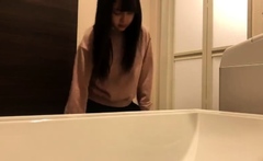 Cute amateur asian web cam girl playing with her toy